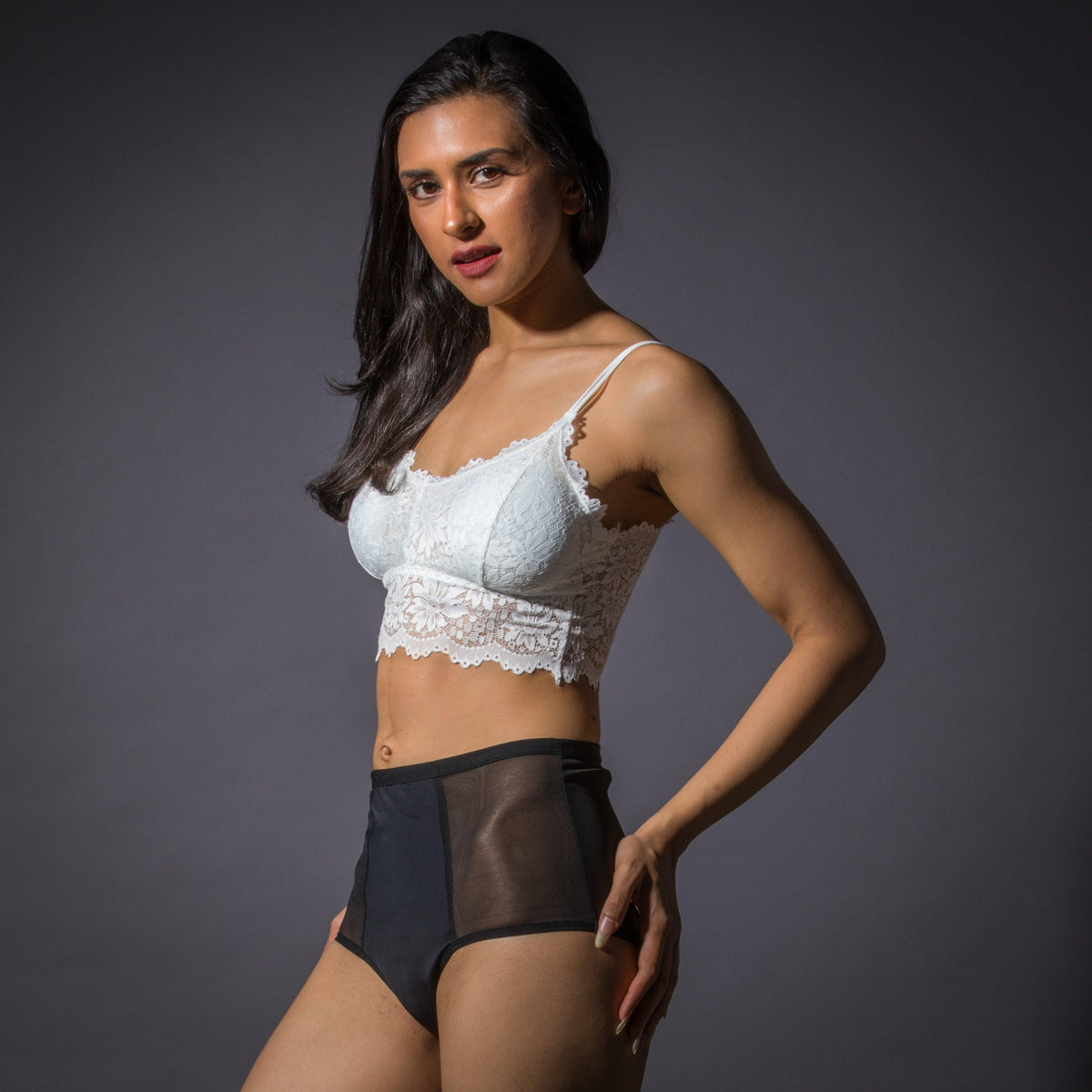 Woman wearing leak-proof high-waist black period underwear and white lace bralette